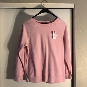 A crewneck sweater w/a peace sign